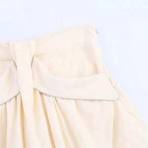 Elegant off-white A-line skirt waist detail with beaded edges and invisible zipper closure