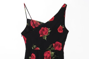 Detail view of red rose floral print on black fabric with invisible side zipper