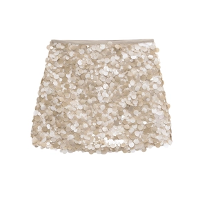 Close-up of champagne sequins and fine stitching on the waistband of this A-line mini skirt