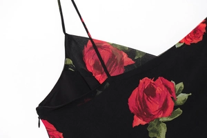 Detail of red rose floral print on black fabric with hidden zipper and thin strap