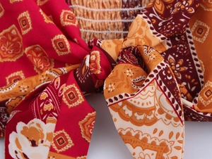 Macro detail of bohemian paisley print fabric with knot design and elastic pleats