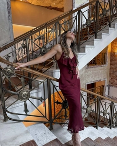 Detailed view of burgundy ruffle neckline and delicate straps on elegant maxi dress