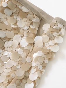 Close-up of beige sequin skirt featuring an invisible zipper and detailed stitching