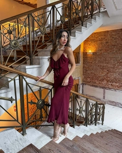 Detail of burgundy spaghetti strap dress with layered ruffles and satin finish