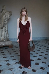Detail of burgundy backless maxi dress with tiered ruffles and premium chiffon fabric
