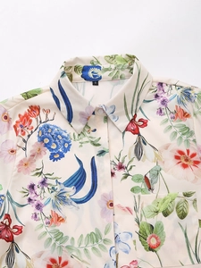 Detailed close-up of floral satin shirt showing vintage flower patterns and buttons