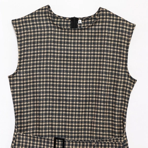 Detail view of sleeveless plaid dress with round neck, back zipper, and waist buckle