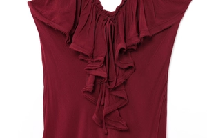 Macro shot of tiered ruffles and textured crepe fabric on a deep red dress neckline