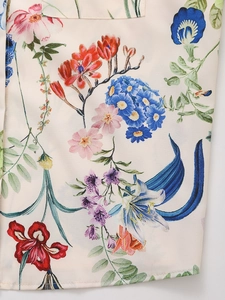 Detail of floral print satin fabric with pocket stitching on a spring fashion shirt