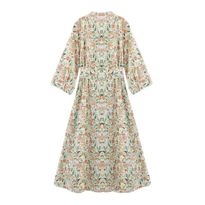 Floral print long sleeve maxi dress with cinched waist and pleated skirt on white background