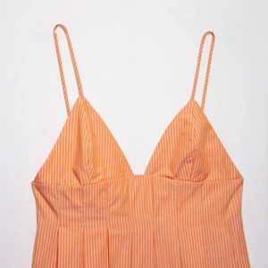 Summer orange and white vertical striped camisole top with V-neck and pleated detailing