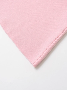 Detail of pink knitted short sleeve dress showing premium rib-knit texture and material