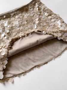 Macro detail of champagne gold sequin skirt featuring large round sequins and soft inner lining