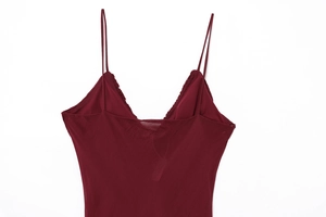 Close-up of dark red V-neck dress featuring thin straps and ruffled pleated edge details