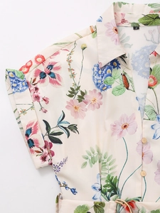 Detail view of floral silk-texture mini dress with shirt collar and matching waist belt