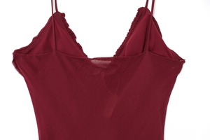 Detail of burgundy backless summer dress featuring ruffled neckline and spaghetti straps