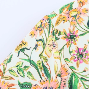 Close-up of vintage floral print fabric featuring pink and yellow flowers on light base