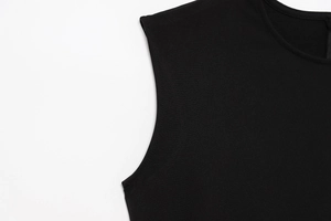 Detailed close-up of the round neckline and stitching on a black sleeveless summer dress