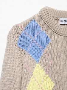 Close-up of beige argyle knit cardigan featuring blue and yellow diamonds with pink stitching