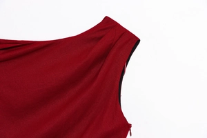 Detail of dark red sleeveless dress showing hidden side zipper and linen fabric texture