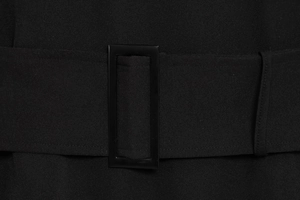 Detailed macro view of black sleeveless dress waist with matching belt and resin buckle