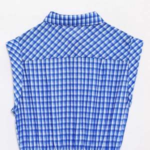 Detail view of the blue and white gingham patterns on the back of the cotton jumpsuit