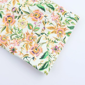Detail of floral printed sleeve with precise stitching on white summer dress fabric