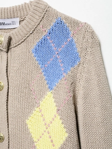 Close-up of oatmeal knit cardigan featuring blue and yellow diamond pattern and gold buttons