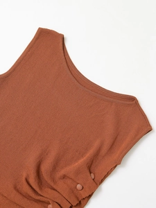 Close-up of rust red knit top featuring rib-knit collar and decorative side buttons