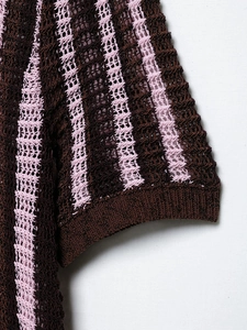Close-up of knit polo shirt sleeve with pink and brown vertical stripes and mesh texture