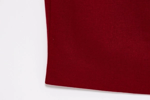 Detail shot of the dark red sleeveless dress fabric with premium textured weaving