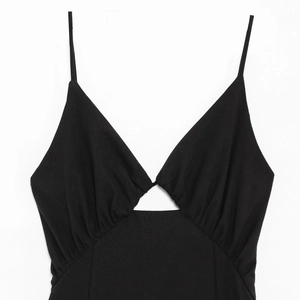 Chic black sleeveless slip dress featuring a deep V-neck and front cutout design