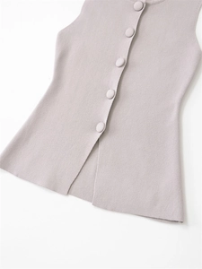 Close-up of lilac knitted vest with delicate matching single-breasted button detail