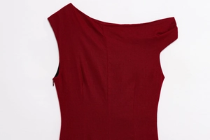 Detailed macro view of the burgundy asymmetrical sleeveless dress with metal accents