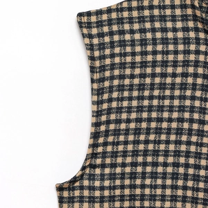 Detail of armhole and shoulder seams on black and yellow plaid sleeveless dress