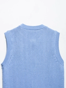 Detail shot of the sky blue chunky knit vest showing ribbed round neck and thick texture
