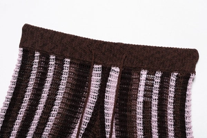 Detailed macro view of elastic ribbed waistband on striped crochet knit fabric
