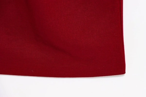 Detailed close-up showing the hem stitching and texture of the burgundy sleeveless dress