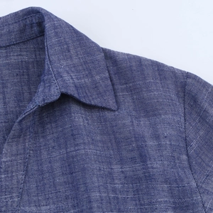 Detail of navy blue chambray shirt collar and fabric texture with fine stitching