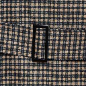 Close-up of black and tan mini-check woven dress with matching belt and rectangle buckle