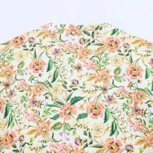 Close-up detail of the floral print pattern and collar stitching on women's summer dress