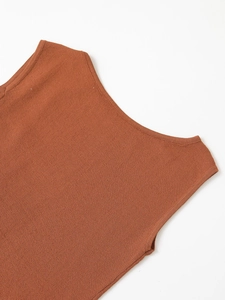 Close-up of the fine knit texture and ribbed edge detail on this terracotta summer top