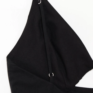 Macro shot of black twill fabric detail and metal ring strap connection on dress