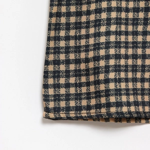 Detailed macro view of the gingham fabric hem with professional stitching on sleeveless dress