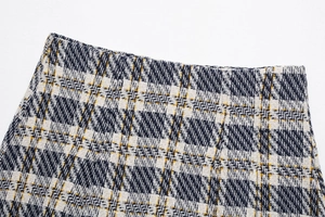 Détail rapproché de la texture du tissu en tweed de haute qualité tissé en crème et bleu