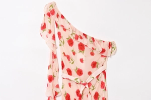 Close-up of one-shoulder floral summer dress with ruffle neckline and chiffon rose print