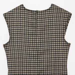 Detail view of the back of a plaid sleeveless dress with a hidden zipper closure