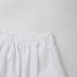White high-waist pleated skirt for women featuring fine stitching and smooth fabric detail