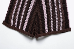 Detail of open-knit mesh texture and dark brown vertical stripes on casual shorts