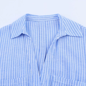 Detailed view of the classic collar and blue white striped fabric on the shirt dress